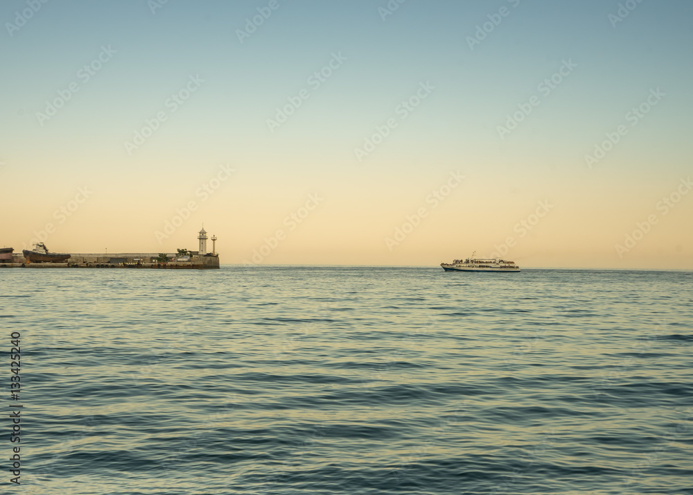 Pleasure boat coming to the seaport of Yalta. Crimea, Russia