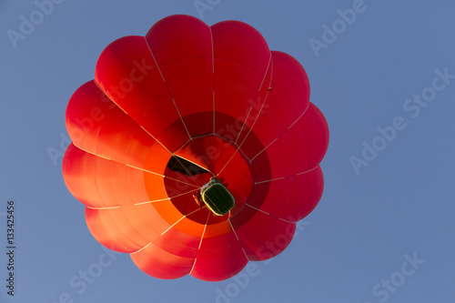 red hot air balloon on the blue sky