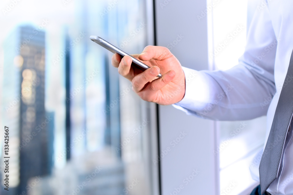 business, people and office concept - businessman using a smart business, people and office concept - businessman using a smart