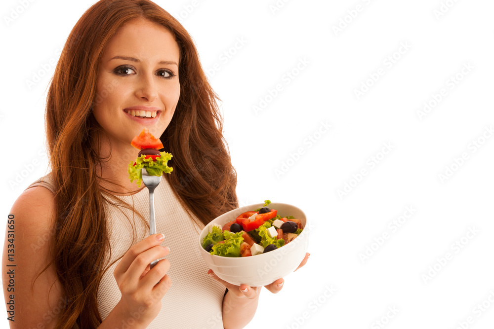 healthy eating - woman eats a bowl of greek salad isolated over healthy eating - woman eats a bowl of greek salad isolated over