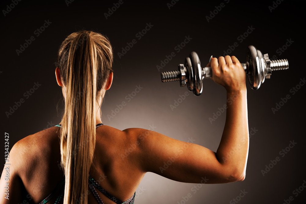 fit woman workout with dumbbells in gym studio photography of a fit woman workout with dumbbells in gym studio photography of a
