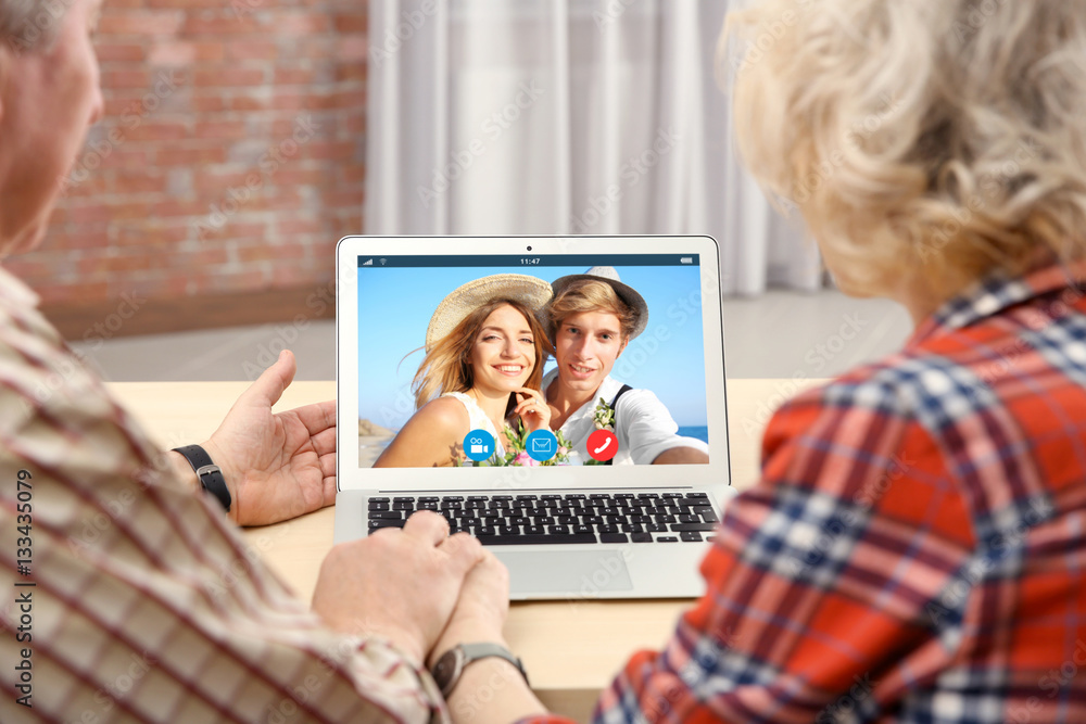 Video call and chat concept. Senior people video conferencing on laptop