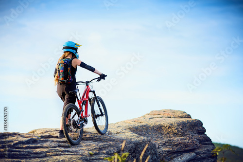 Female MTB mountain biker enjoys the view during cycling trip photo
