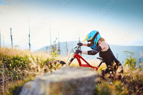 MTB mountain biker walking uphill with bike photo