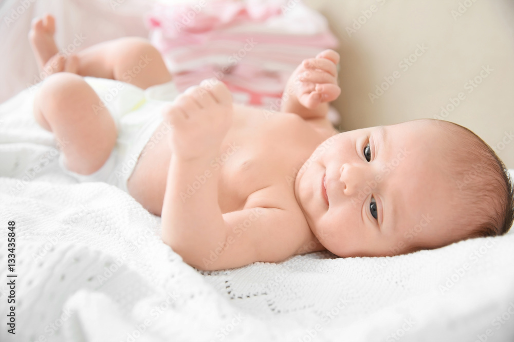 Newborn baby girl, 7 days old, lying on soft fluffy blanket Newborn baby girl, 7 days old, lying on soft fluffy blanket