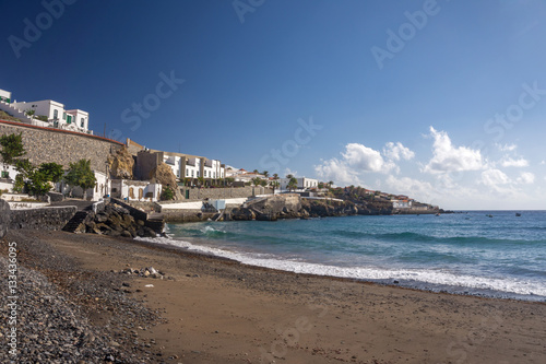 Beach with black sand and view of the city on the Tenerife island. Canary islands