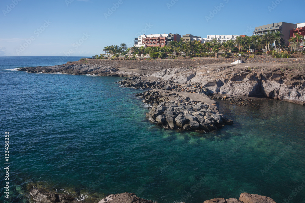 Obraz premium View of the blue Bay and the colored houses on the rock. Tenerife island, Spain