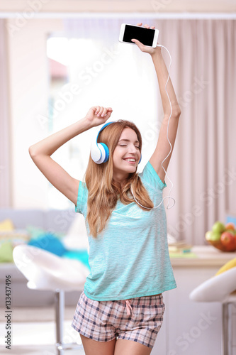 Beautiful young woman liste...