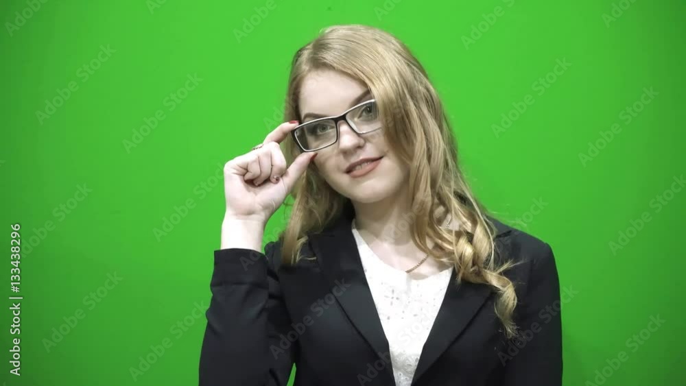 Girl in black jacket smiling adjusts her glasses. Business woman Girl in black jacket smiling adjusts her glasses. Business woman