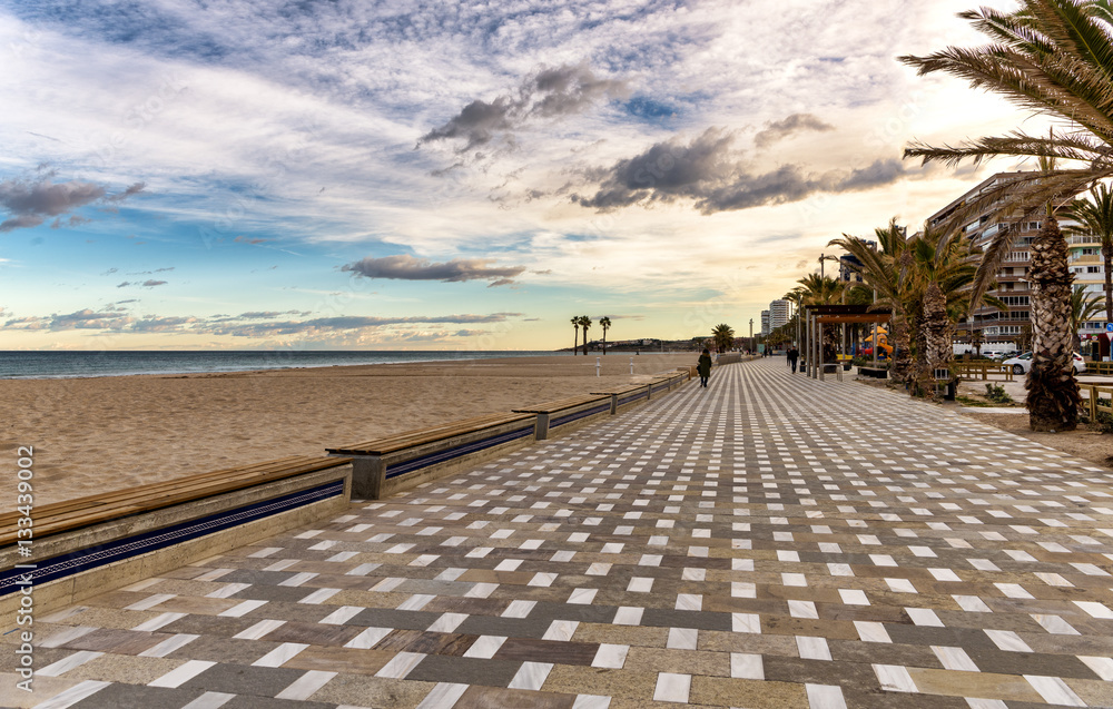 Long tile boardwalk in serene Mediterranean beach scene - obrazy, fototapety, plakaty 