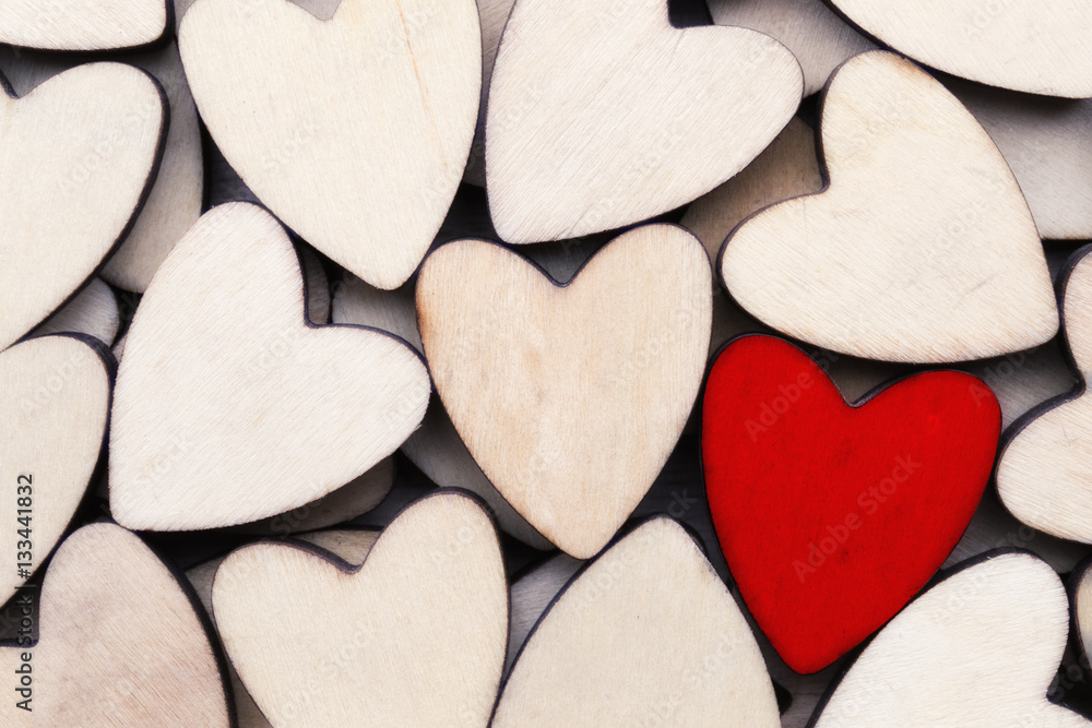 Obraz premium Wooden hearts, one red heart on the heart background.