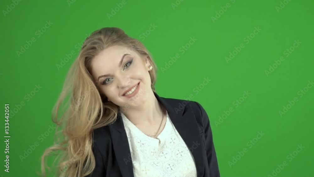 A young girl in a black jacket effectively removes by hand a strand of hair from his forehead ,tossed the hair A young girl in a black jacket effectively removes by hand a strand of hair from his forehead ,tossed the hair