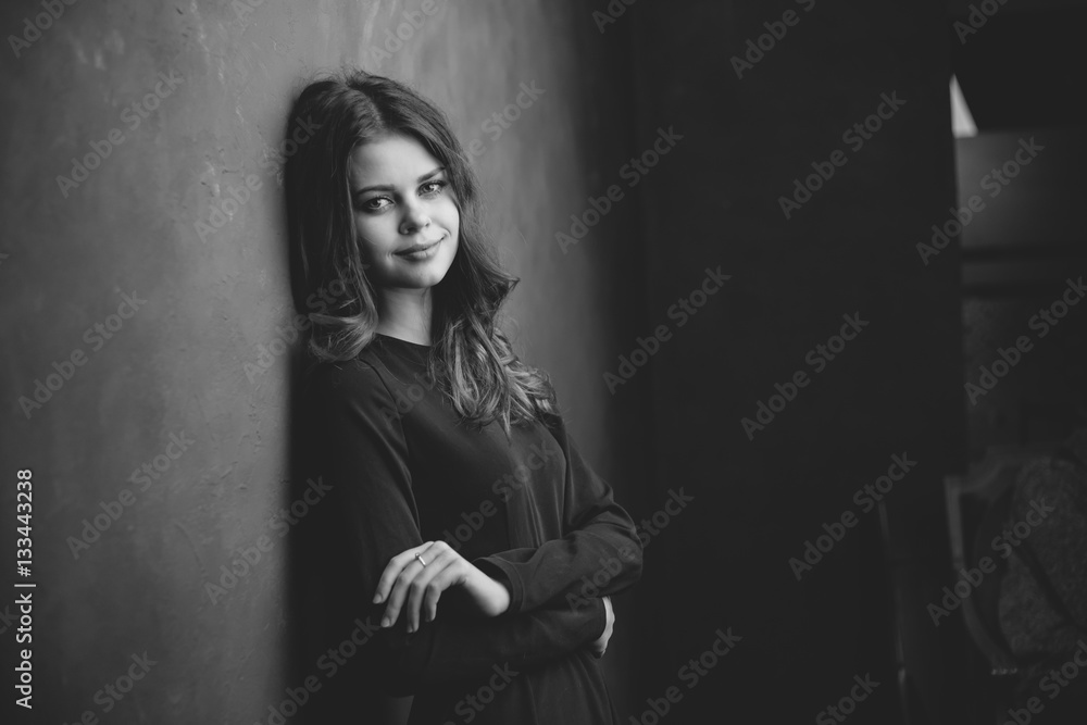 beautiful woman standing near the wall, room, black and white photo beautiful woman standing near the wall, room, black and white photo