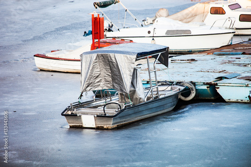 small boats on frozen lake