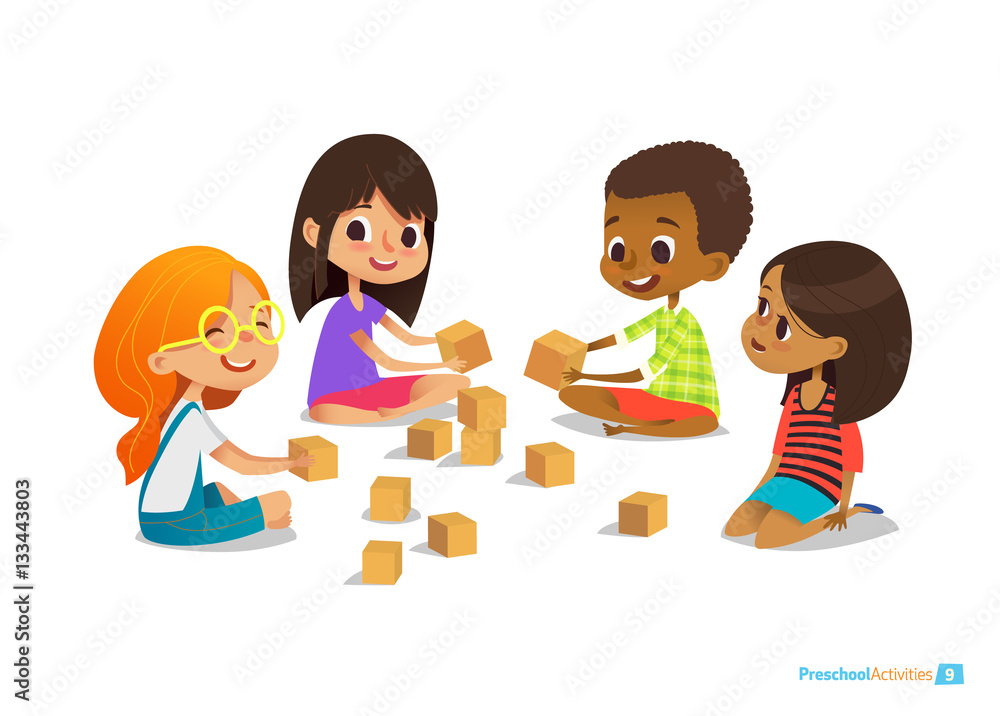 Laughing and smiling kids sit on floor in circle, play with toy cubes