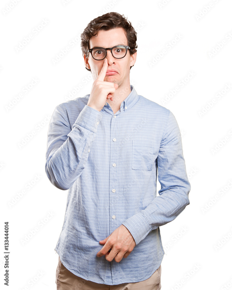Concerned young man with a bad smell gesture Concerned young man with a bad smell gesture