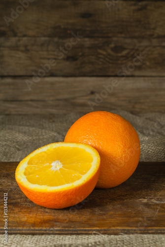 Oranges Fruits and Orange Slice on Wooden Table and Retro Fabric