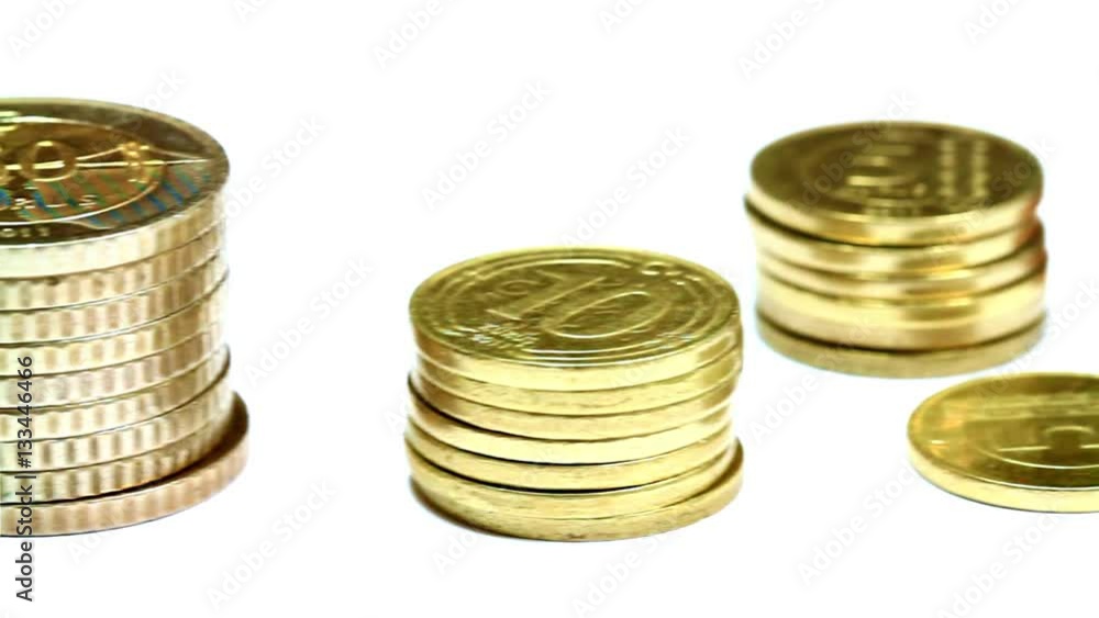 Close up of coin stacks. Pan Video. Camera pans over coins on white background. Close up of coin stacks. Pan Video. Camera pans over coins on white background.