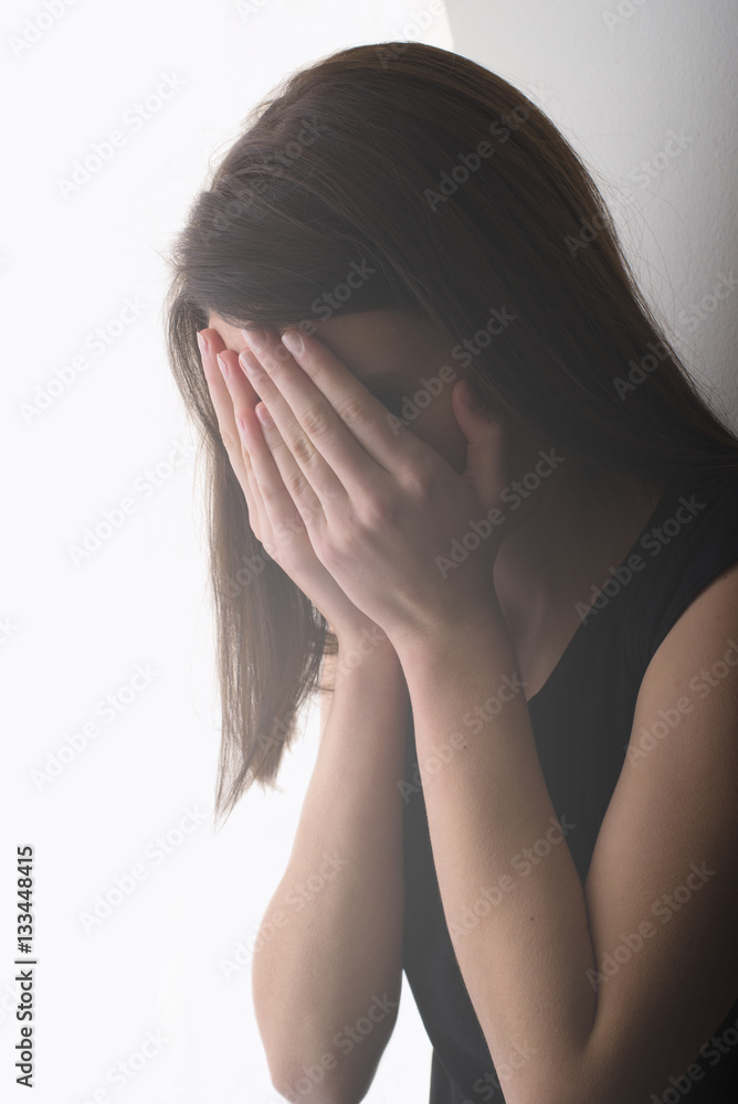 Download A Woman Holding A Sad Face On Her Face