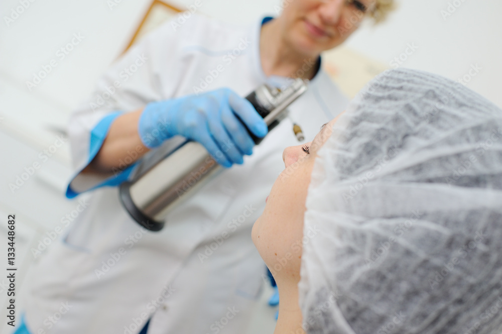 Doctor makes the patient cryotherapy procedure - Cryomassage - cold treatment Doctor makes the patient cryotherapy procedure - Cryomassage - cold treatment