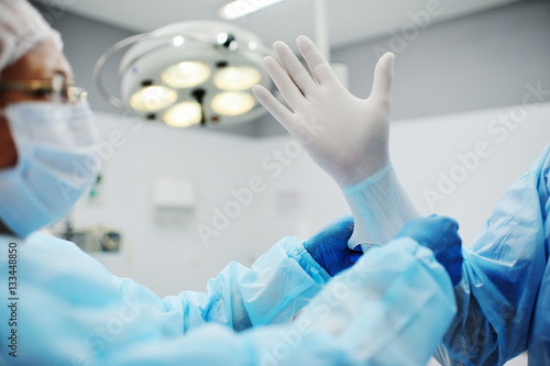 surgeon s hands in gloves closeup. Surgeons team preparing for a complex operation.