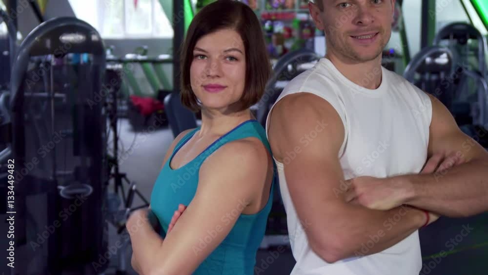 Stockvideon Young fit couple showing their thumbs up at the gym. Male