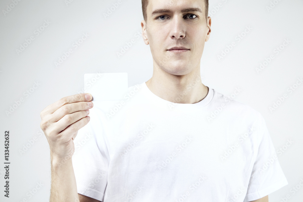 Attractive handsome businessman holding, showing empty business card, space for layout, with white background Attractive handsome businessman holding, showing empty business card, space for layout, with white background