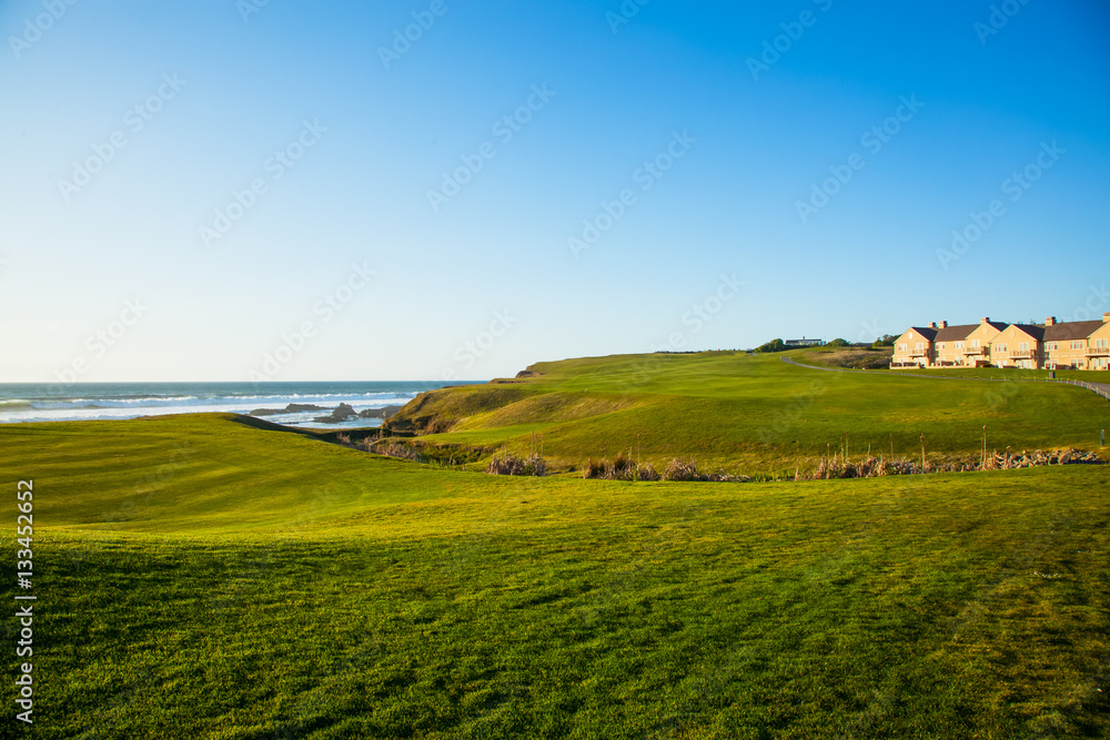 Half Moon Bay grass field and villa houses.  Golf course.