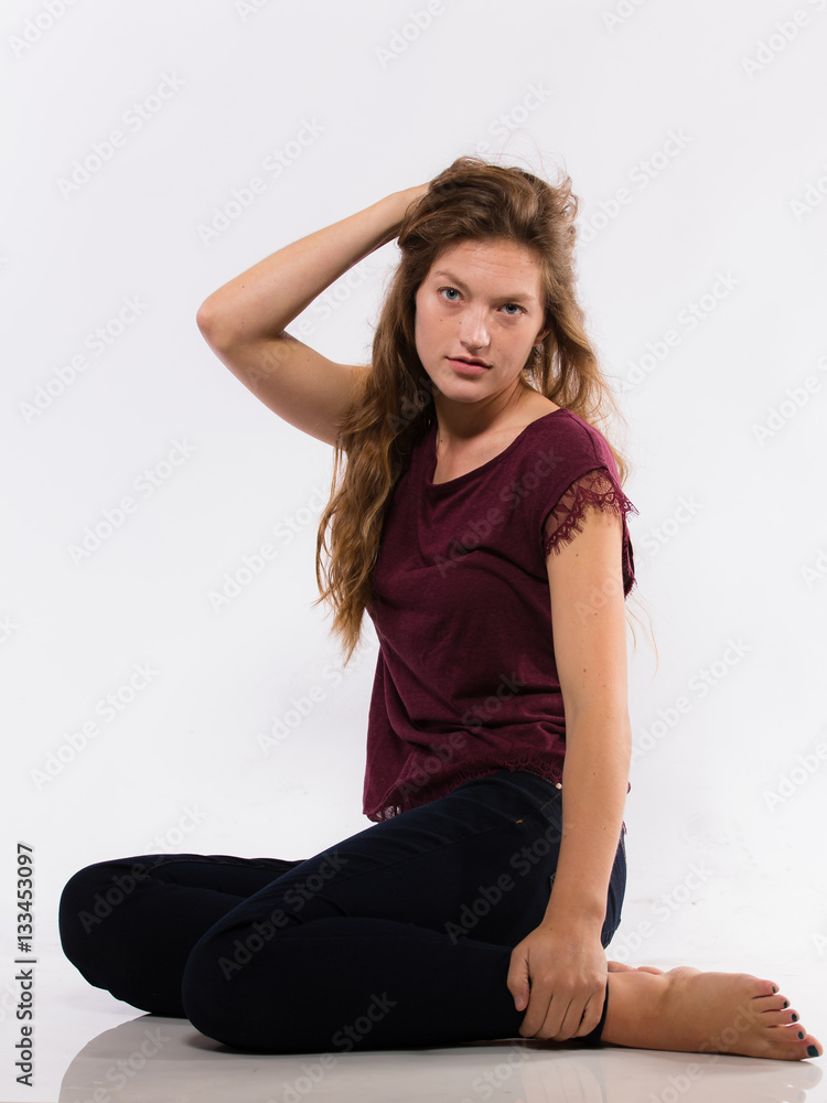 Young caucasian woman sits barefoot Young caucasian woman sits barefoot