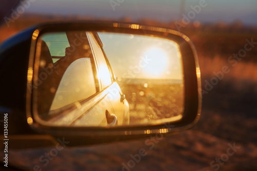 reflection of sun in car mirror