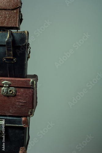 Background stack of old shabby suitcases form a tower