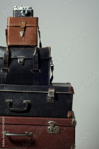 Stack of old shabby suitcases and camera