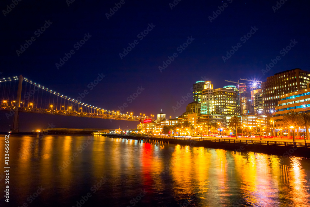 Night view of San Francisco and the Bay Bridge.  Cityscape from Pier 14. Night sky.