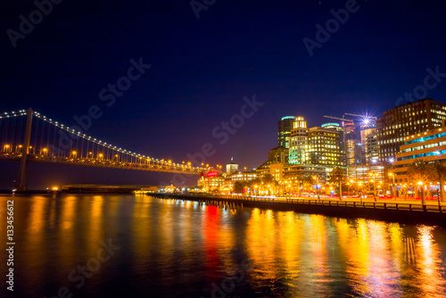 Night view of San Francisco and the Bay Bridge.  Cityscape from Pier 14. Night sky.