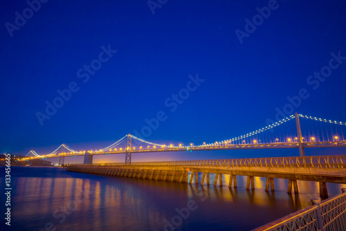 San Francisco Bay Bridge and Pier 14 at night with street lights