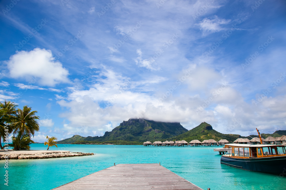 Pier in Bora Bora island.  Dock with a boat.  Paradise honeymoon destination.