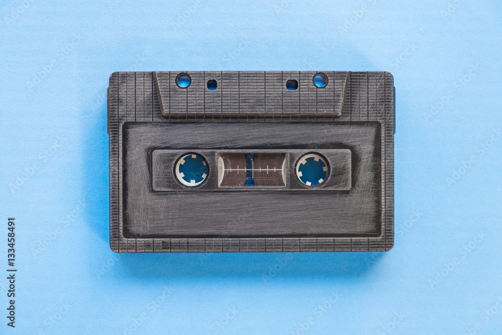 Cassette tape over paper background, top vie Cassette tape over paper background, top vie
