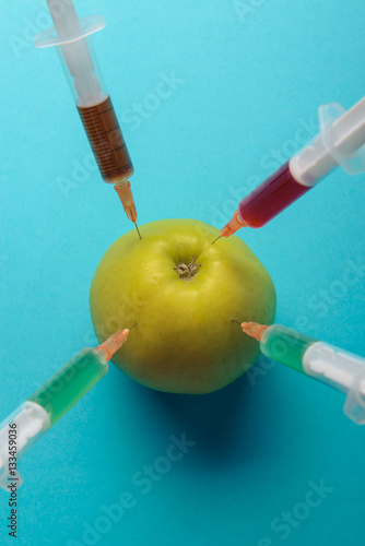 Chemical additives in food or genetically modified fruit concept.
