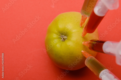 Chemical additives in food or genetically modified fruit concept.