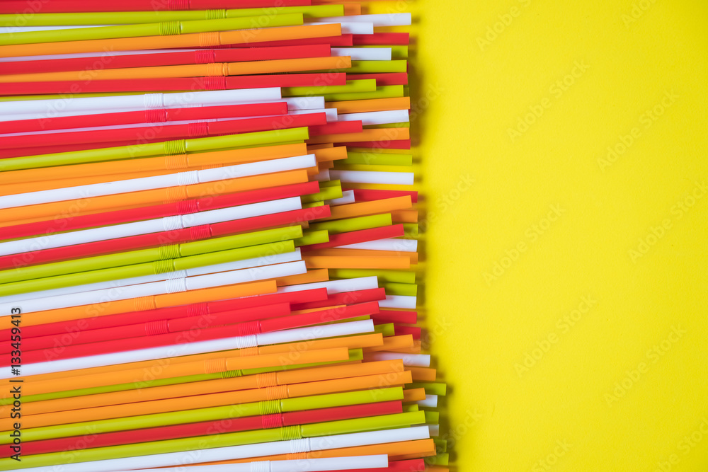 Fototapeta premium Colorful drinking straws for the color background. Abstract a colorful of plastic straws used for drinking water or soft drinks
