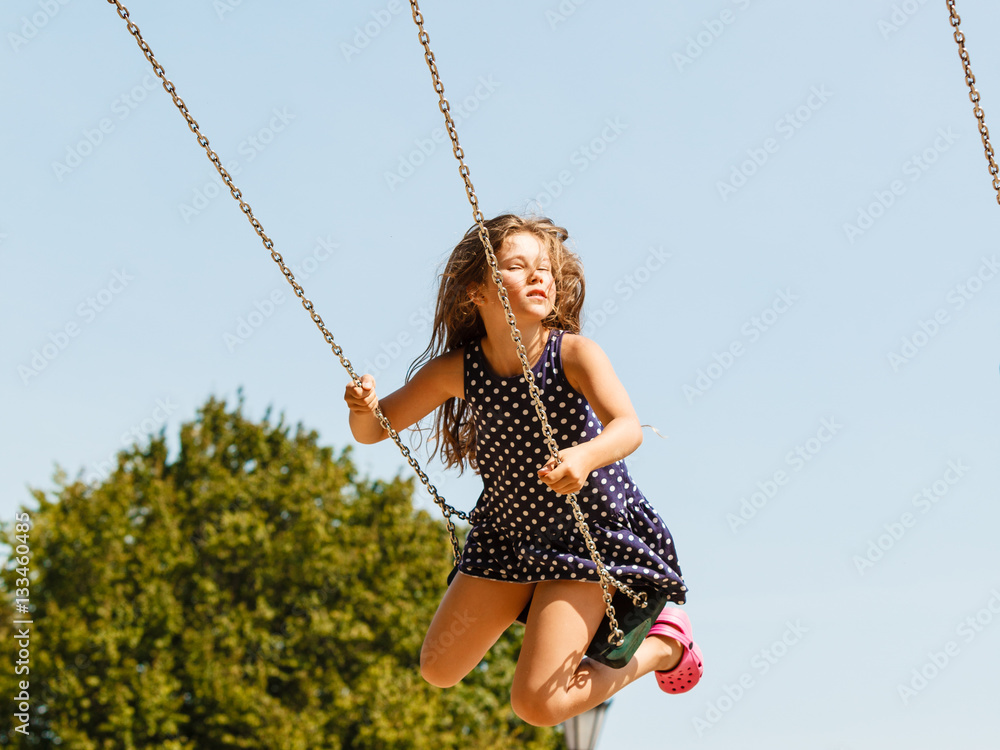 Girl swinging on swing-set. Girl swinging on swing-set.
