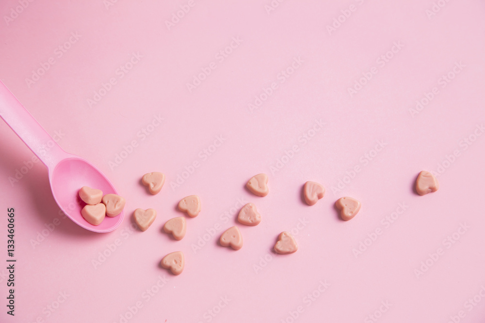 A pink spoon with pink heart candy A pink spoon with pink heart candy