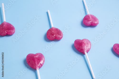 Heart lollipop on blue background.Minimal concept.