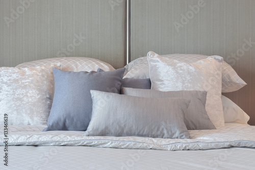 Fototapeta Naklejka Na Ścianę i Meble -  Modern bedroom interior with gray and striped pillows on bed