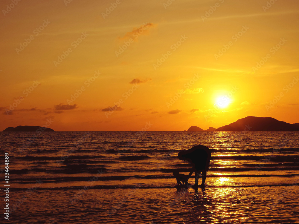 father and son on the beach in sunset.jpg