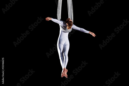 Fototapeta Naklejka Na Ścianę i Meble -  Young woman circus air gymnast