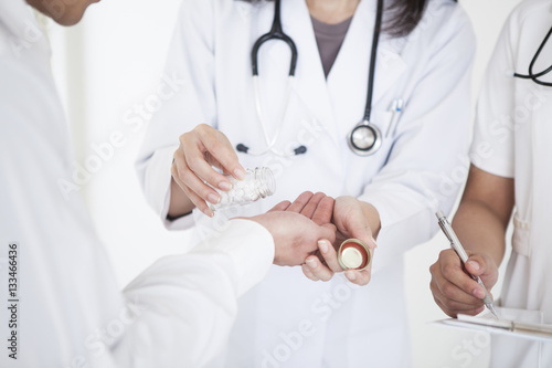 The doctor prescribes the medication to the patient
