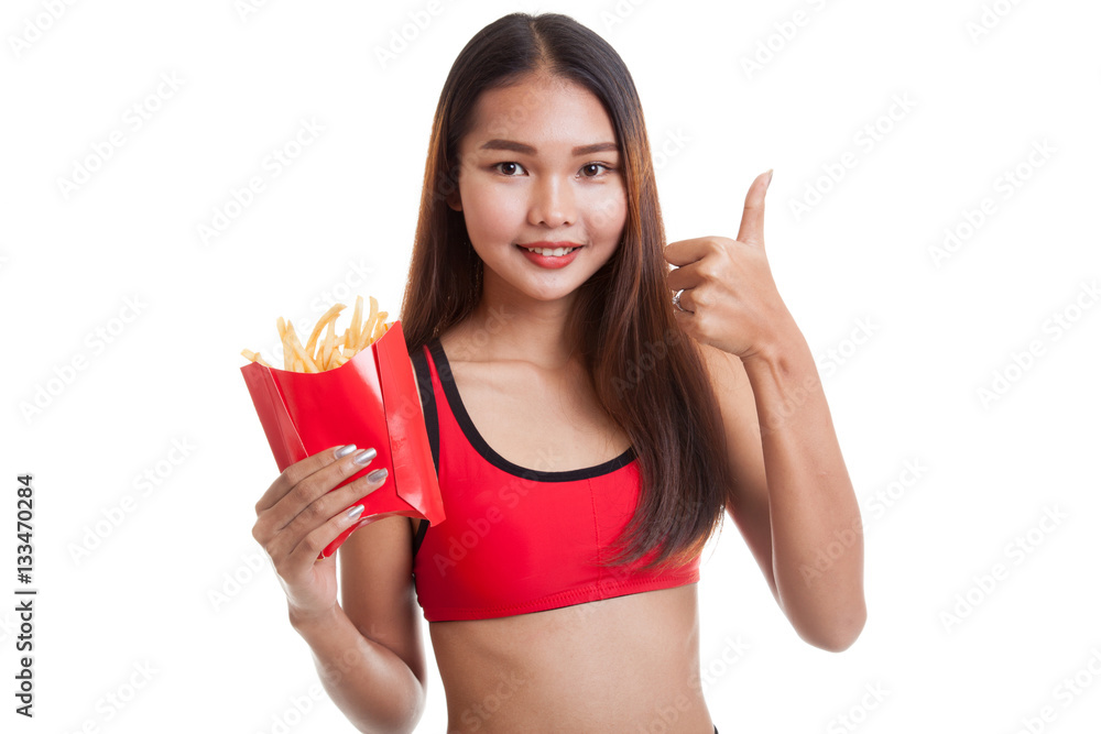 Asian healthy girl eat  french fries show thumbs up.