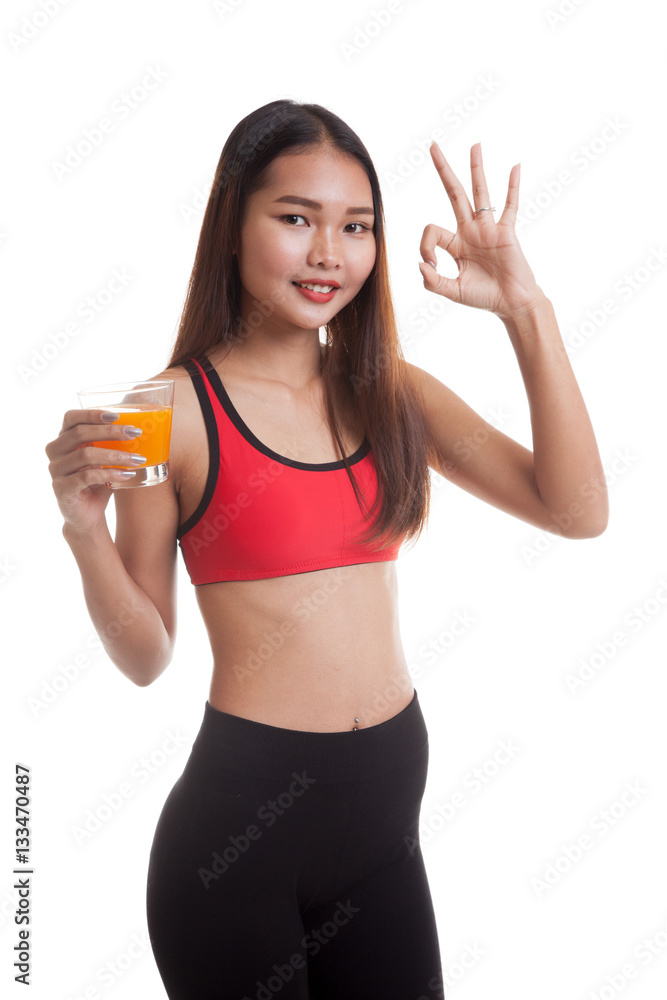 Beautiful Asian healthy girl drinking orange juice show OK sign Beautiful Asian healthy girl drinking orange juice show OK sign