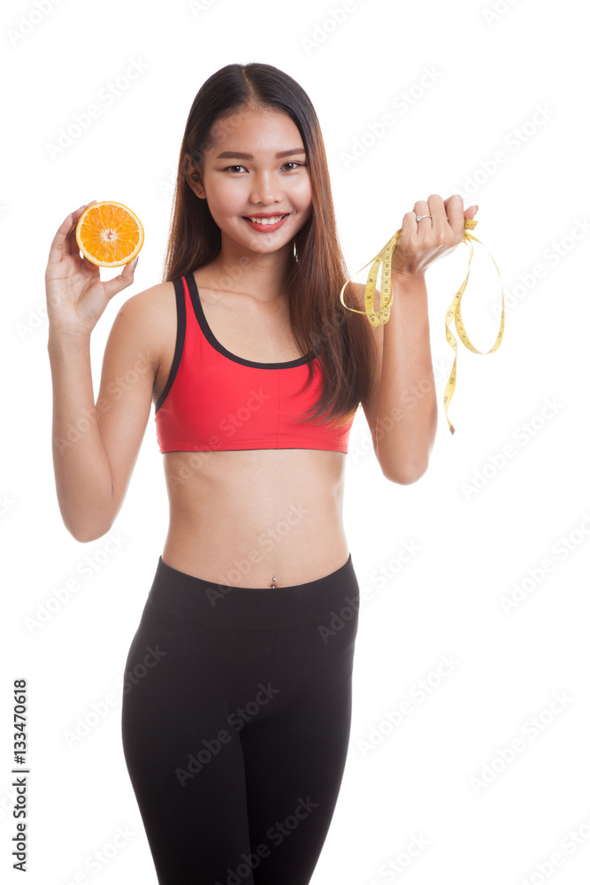 Asian healthy girl on diet with orange fruit and measuring tape. Asian healthy girl on diet with orange fruit and measuring tape.
